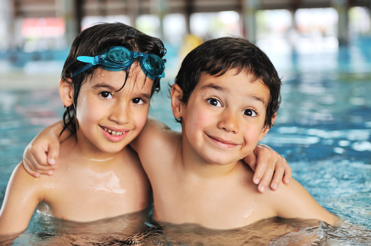 Summertime and swimming activities for happy children on the pool