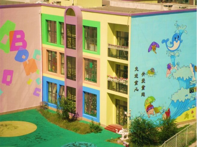 colorful school building with cartoon wave painted on the side